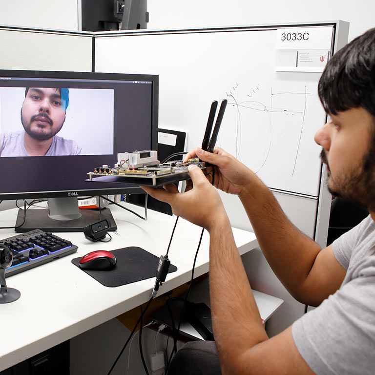 A student works with security camera technology. 